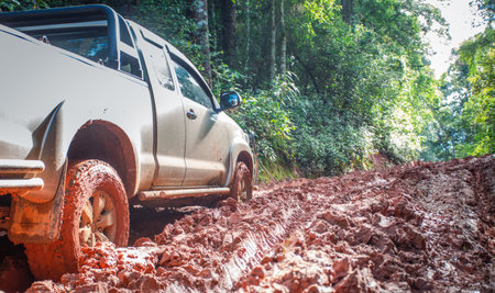 Muddy off-road vehicles, off road trip on mountain road sunset beautiful nature
