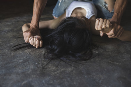 The concept of sexual harassment against women and rape,man's hand holding a woman hand, sexual abuse  concept, human  trafficking, domestic violence.の写真素材