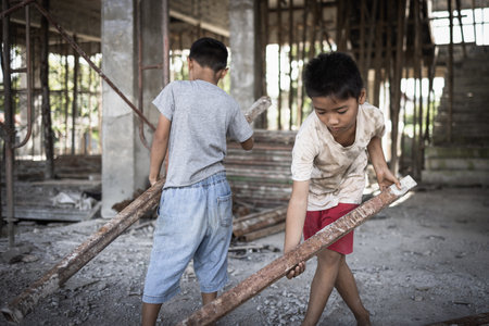 Poor children forced to do construction work, child labor, abuse To the rights of children, victims of human trafficking, World Day Against Child Labor.の写真素材