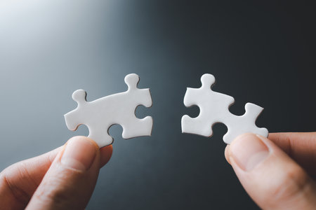 Closeup hand of woman connecting jigsaw puzzle, Business solutions, success and strategy conceptの写真素材
