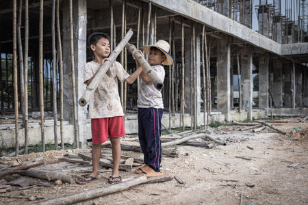 Concept of child labor, poor children being victims of construction labor, human trafficking, child abuse.の写真素材
