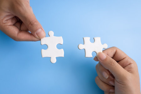 Hand of woman connecting jigsaw puzzle, Business solutions, success and strategy, Business partnership concept.の写真素材