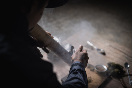 A man prepares marijuana on a cutting board to smoke, person who smokes drugs, drug addict, Drugs...
