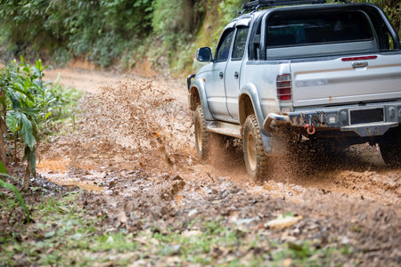 Cars running on off-road roads and splashing mud on natural paths. Off-road travel on muddy road....