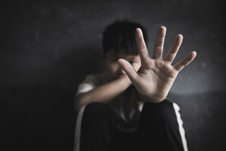 Children raise their hands to stop violence against children. Stop abusing violence. trafficking in human beings.の写真素材