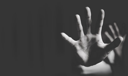 Close up of  woman showing stop gesture with hand blurred background. Stop violence against women....