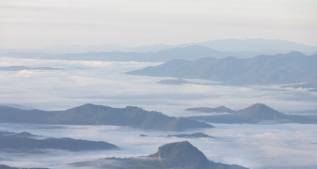 Mist with big mountain in the morning. beautiful mist sea on top moutain, Sunrise Scene of Mountain Range and Fog.の写真素材