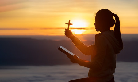 silhouette of a man Praying hands with faith in religion and belief in God On the morning sunrise background.  Prayer position.の写真素材