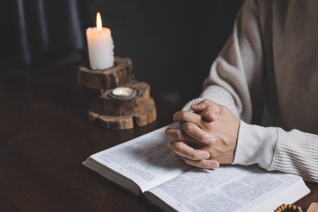 Woman hands praying for blessing from god. Praying hands with faith in religion and belief in God on blessing background.の写真素材