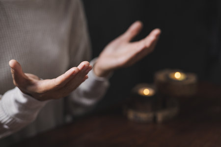 Person hands open palm up in the morning with sunrise.