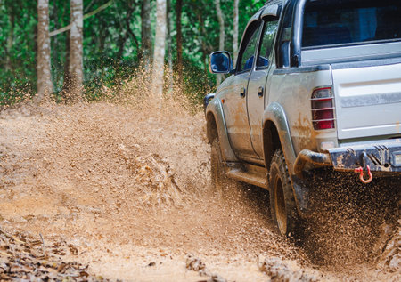 Offroad car. 4x4 off-road suv car stuck in mud. Adventure travel concept background.の写真素材