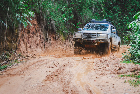 Off-road vehicles driving on muddy tracks. Mud and water splash in off-road racing. Offroad car expeditionの写真素材