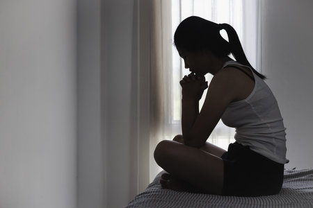 Asian woman sitting on the house area Feeling sad, tired and worried about depression, mental health problems and heartbreaking concept.の写真素材