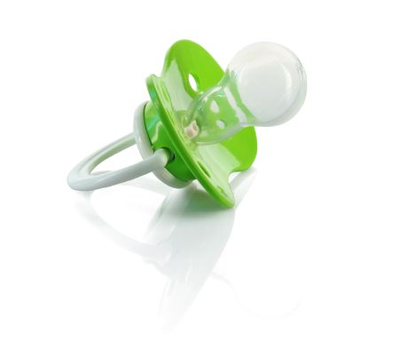 Baby silicone pacifier in green color, isolated on white background. 