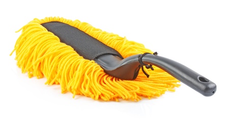 Modern yellow fluffy, duster with plastic black handle isolated on white background 