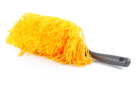 Modern yellow fluffy, duster with plastic black handle isolated on white background の写真素材