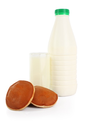 bottle and glass of milk with cookies isolated on white, food photoのeditorial素材