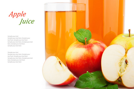 Apple juice in glass jar and red apples with green leavesの写真素材