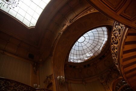 Rich entrance hall in the Lviv ancient casino with wooden staircases