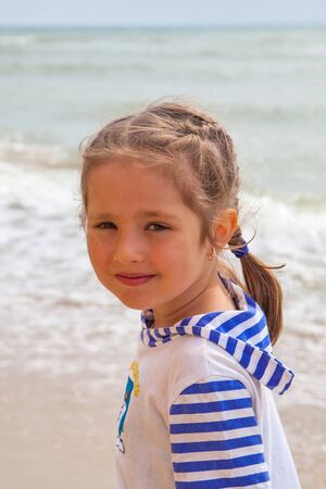 Little girl at tropical sand beach, vacation sea landscapeの写真素材