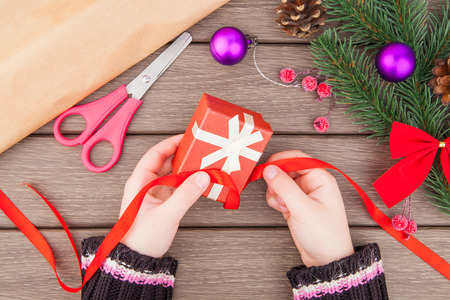 Christmas gift packing and decoration on wooden backgroundの写真素材