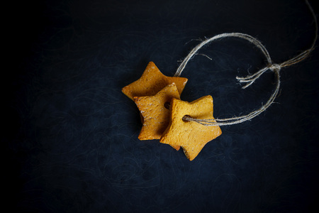 Three star cookies lace-bound on black, stylish food photoの写真素材