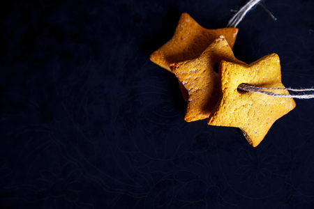 Three star cookies lace-bound on black, stylish food photo の写真素材