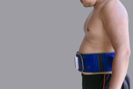 Obese men with belt slimmingの写真素材