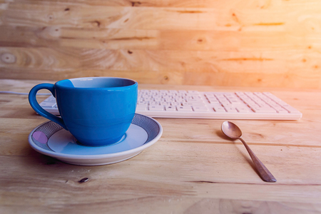 Coffee cup on wooden floorの写真素材