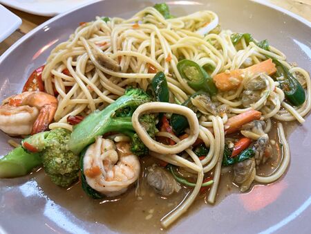 Close up of Stir fried noodles with shrimp and vegetables on the plate.の写真素材