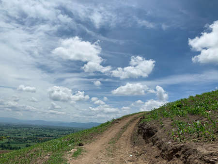 Rough road on the mountian and blue cloud skyの写真素材