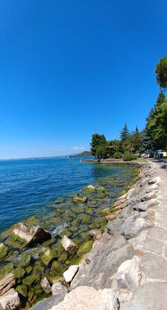 panorama of lake garda in beautiful quay sunny dayの写真素材