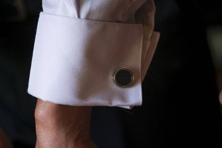 mother of the groom fastening cuffs and cufflinks before the wedding