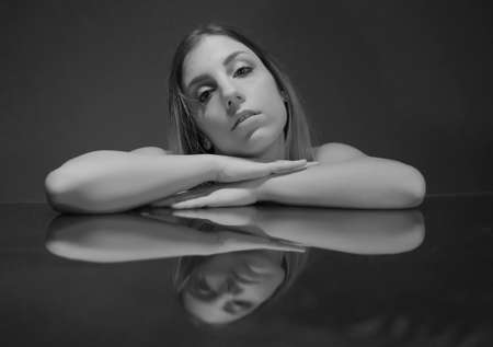 portrait of model reflected on colored mirror