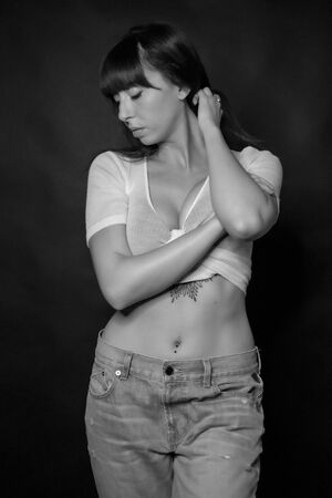 full body of beautiful dark-haired girl with low-cut long hair and white t-shirt in black and whiteの写真素材