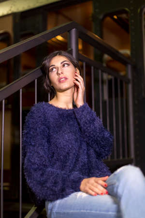 beautiful woman poses for photo portrait dark hair blue sweatebeautiful woman poses for photo portrait dark hair blue sweaterr. High quality photoの写真素材