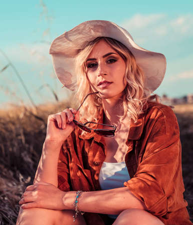 beautiful blonde girl with white hat and icy country. High quality photo