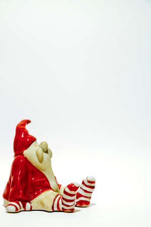 christmas statue of santa claus isolated on white background with sitting santa and striped socks. High quality photoの写真素材
