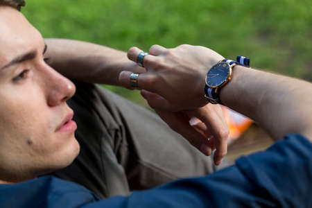 beautiful boy poses among the leaves of a pergola with open shirt and body on display. High quality photoの写真素材