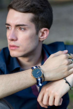 caucasian boy sitting on a handrail in the city center. High quality photoの写真素材