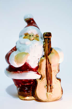 christmas statue of santa claus isolated on white background with lantern in hand. High quality photoの写真素材