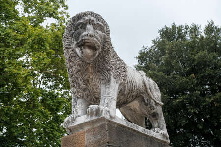 Medieval lion statue in the park of the ancient city walls of Lucca, Italy. High quality photoの写真素材