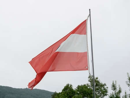 Austrian flag waving over cloudy sky. High quality photoの写真素材