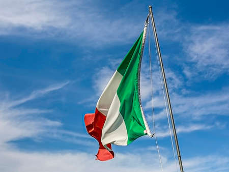 Italian flag waving over blue sky. High quality photoの写真素材