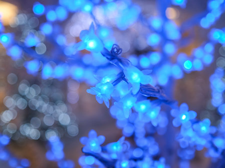 Tree decorated for Christmas with blue flower lights. High quality photoの写真素材