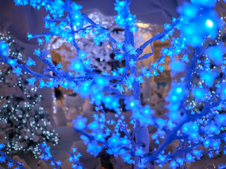 Tree decorated for Christmas with blue flower lights. High quality photoの写真素材