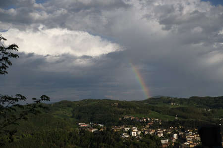 View of a rainbow on the valley from Sarzano Castle in Casina, Reggio Emilia, Italy. High quality photoのeditorial素材
