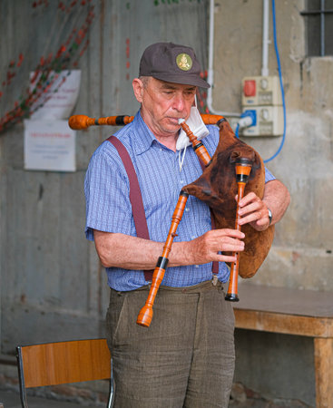 parma, italy - 2021 07 02: Italian bagpipe piva player with musical instrument. High quality photoのeditorial素材