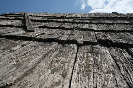 old roof of an alpine hut made of wooden planks damaged by time. High quality photoの写真素材