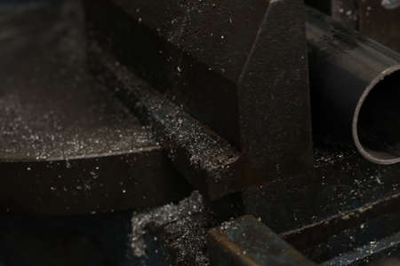 circular saw cutting pipes with metal chips. High quality photoの写真素材